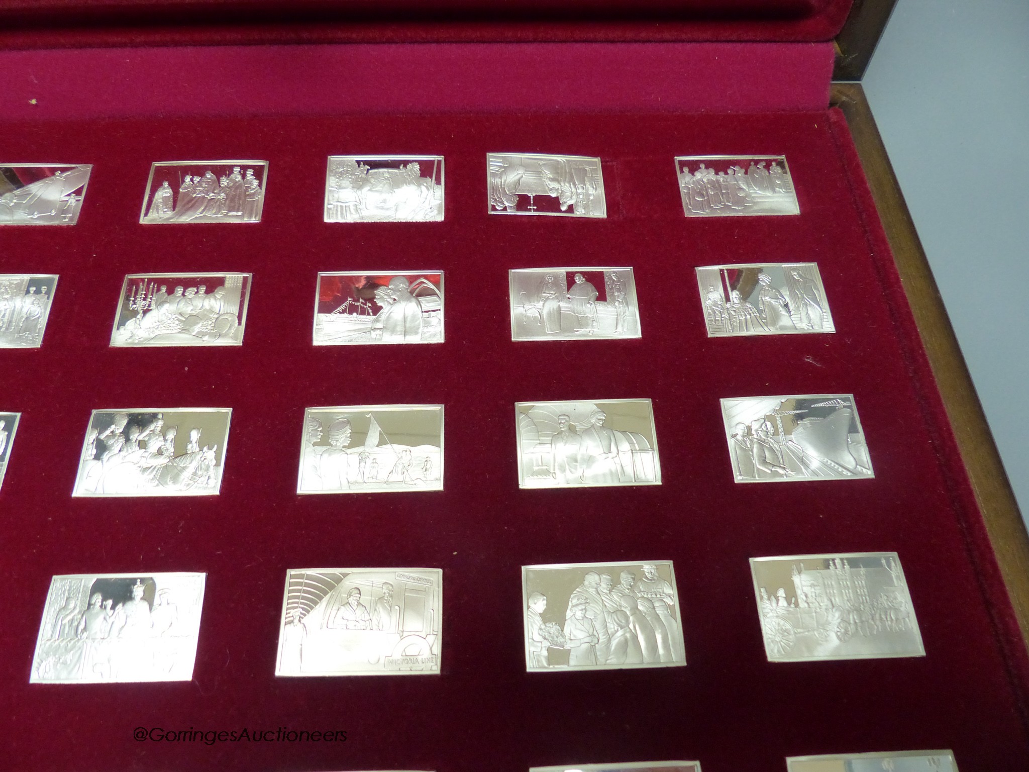 A cased set of twenty five John Pinches 'Elizabeth Our Queen' commemorative silver ingots and one other set of '100 Greatest Cars' miniature silver ingots.